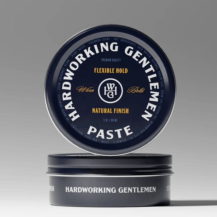 Hardworking Gentlemen paste jar with blue lid on a gray background
