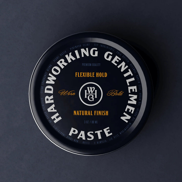 Container of Hardworking Gentlemen Paste with branding on a dark background